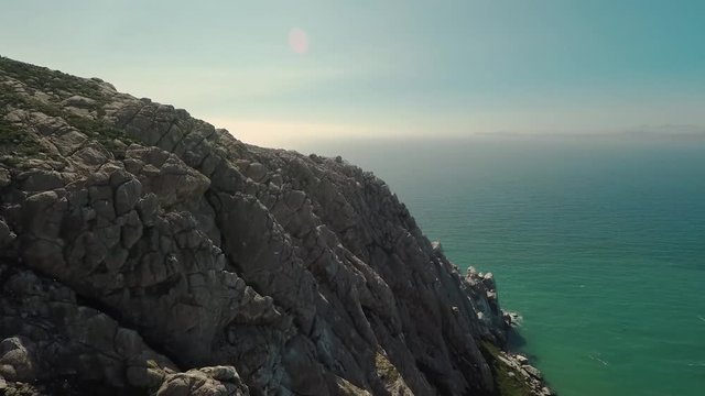 Aerial Drone view of the north side of Morro Rock in Morro Bay, California.