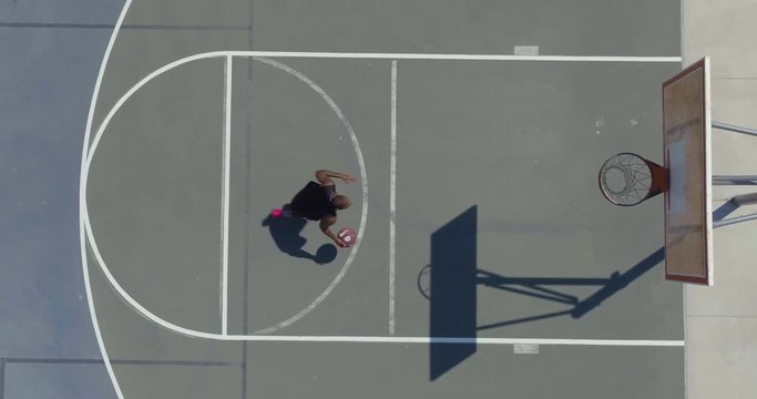 Man Playing Basketball at Park Outside, Overhead Shot