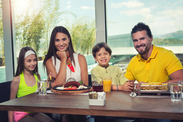 A four-member family having great time in a restaurant