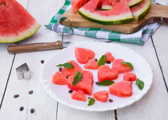 Watermelon cut in heart shape pieces with mint