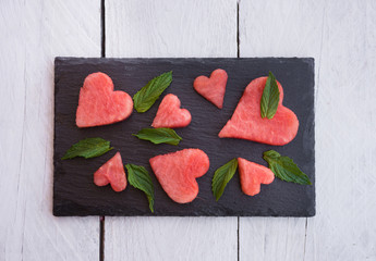 Watermelon cut in heart shape pieces with mint