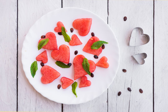 Watermelon cut in heart shape pieces with mint