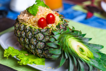 Beautiful tasty dish of pineapple stuffed with rice and chicken