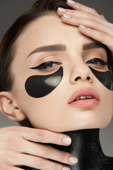 Fototapeta na wymiar Fashion And Beauty. Female Face With Mask And Patches Under Eyes