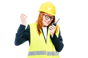 angry girl foreman with radio in hand on white background