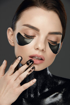 Woman Face With Mask And Patches Under Eyes. Beauty