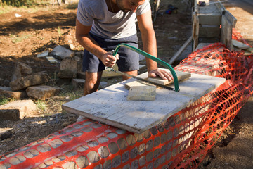 bricklayer building a new wall in a site