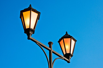 Fototapeta na wymiar Street lamps blue background