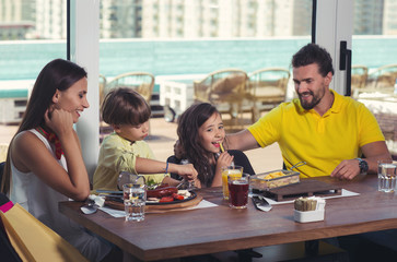 A four-member family having great time in a restaurant