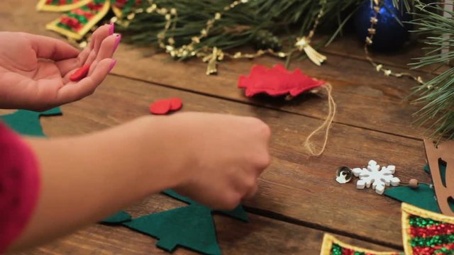 Preparation for the holiday. Making homemade New Year eco-friendly toys on the Christmas tree. Unrecognizable woman sews diy xmas decoration