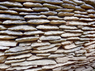Stack of ancient stone roof tiles to be used in the renovation of a ruined French Chateau. Known in France as Lauze roof tiles.
