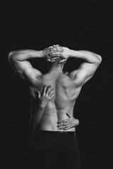 Obraz na płótnie Canvas bodybuilder in the women's arms on black background