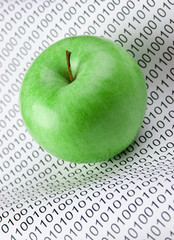 green apple on a binary code