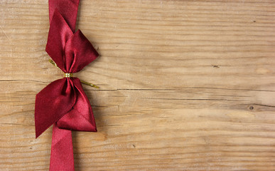 red bow and ribbon on the old wooden background