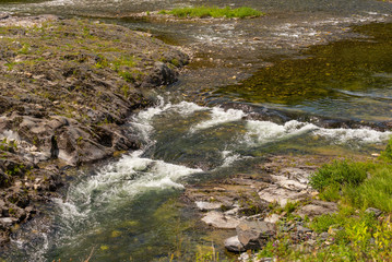 Naklejka na ściany i meble Rapids on a mountain stream