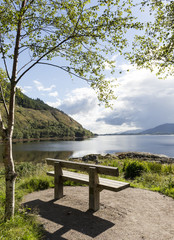 A bench by a loch in the scottish highlands