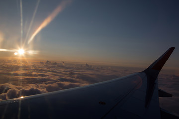 Fototapeta na wymiar Sunrise from the window of a plane