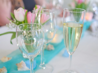 Wine glasses with candle and flowers.