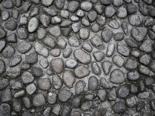 Old cobblestone pavement pattern closeup.