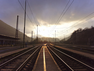 Obraz na płótnie Canvas Beautiful sunset at empty countryside train station.