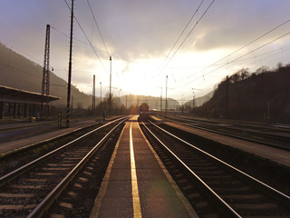 Naklejka na ściany i meble Beautiful sunset at empty countryside train station.