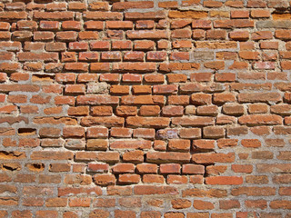 Old weathered brick wall closeup texture.