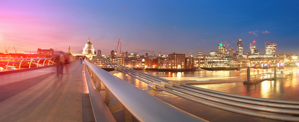 Panoramic view with Millenium bridge and St Paul at sunset in London
