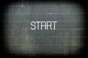 "START" Chalk Writing on Old Chalkboard Background.
