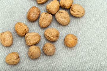 Food background with whole walnuts on cloth and copy space.