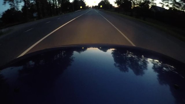 reflection on the hood of the car while driving