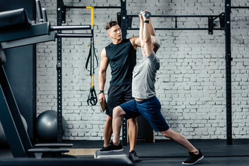 Fototapeta na wymiar sportsman doing lunges with trainer