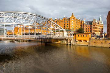 View on the old warehouses and iron bridge in Hafen district of Hamburg city during the sunset in Germany