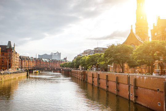 Beautiful cityscape view on the water channel with old church in Hamburg city during the sunset in Germany