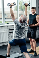 sportsman doing lunges with dumbbells