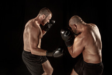 Fototapeta na wymiar Two muscular men fighting, bodybuilders punching each other, training in martial arts, boxing, jiu jitsu