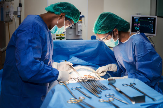 Asian Doctor And An Assistant In The Operating Room For Surgical Venous Vascular Surgery Clinic In Hospital.