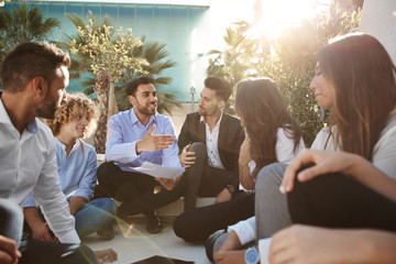 Businessman and businesswoman discussing outside