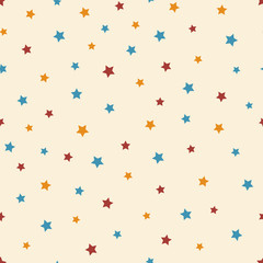 Vector abstract starry seamless pattern on the beige background. Cute blue, red and orange stars.