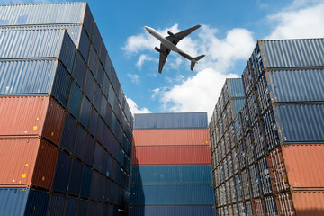 Stack of cargo containers with cargo airplane at import and export area at port. © Prasit Rodphan