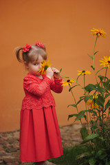 happy little girl with yellow flowers