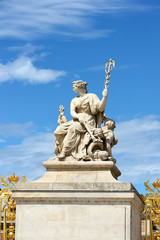 Statues over blue sky at the Palace of Versailles, France