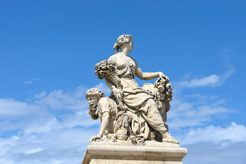 Statues over blue sky at the Palace of Versailles, France.