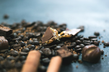 Sweet still life. Coffee beans, chocolate bars and cinnamon sticks.