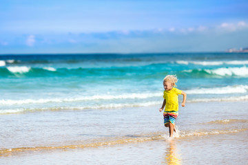 Fototapeta na wymiar Child on tropical beach. Sea vacation with kids.