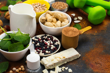 Selection of vegan proteins products: nuts, beans, buckwheat, soy milk. Space for text