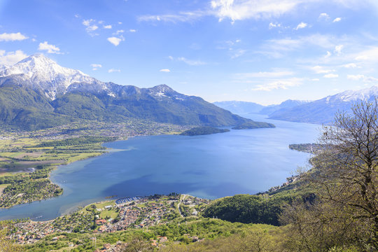 View over Lake Como and villages framed by snowy peaks, Montemezzo, Alpe Zocca, Lombardy, Italian Lakes