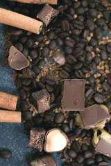 Sweet still life. Coffee beans, chocolate bars and cinnamon sticks.