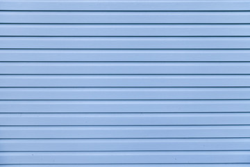 Blue vinyl wooden siding panel background with imitation wood texture.