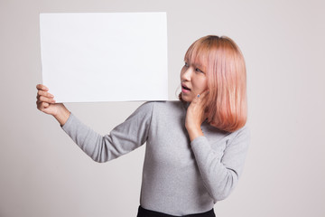 Naklejka premium Young Asian woman surprise with white blank sign.