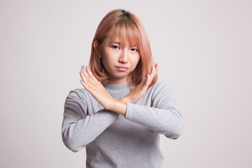 Beautiful young Asian woman say no.
